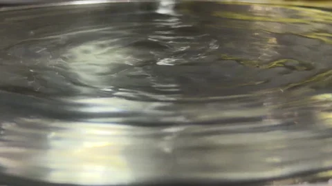 Water Surface Ripples Creating Drips and Draining Sounds Stock Footage 329017443