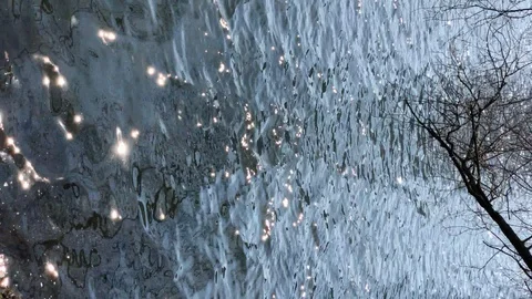 Water surface with ripples glittering on the sun. Vertical orientation Stock Footage 124865783