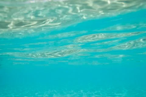 Water surface seen from underneath, sunlight reflecting. Stock Photos