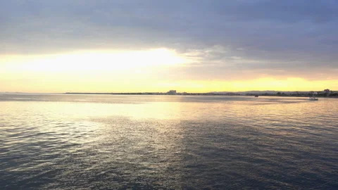 Water surface, skyline and sky in sunset light in 4K. Stock Footage 119945894