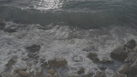 Water surface with small waves washing rocky shore at night Stock Footage 271293983