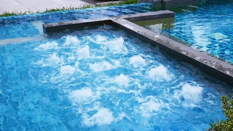 Water surface splashing and bubble rising in swimming pool Stock Footage 100533642