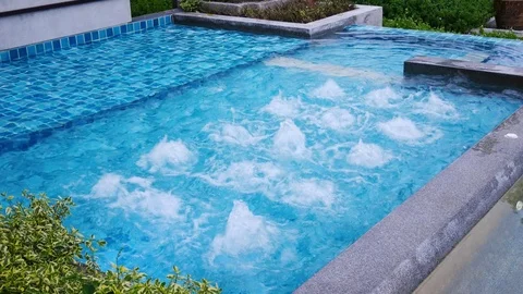 Water surface splashing and bubble rising in swimming pool Stock Footage 100533756