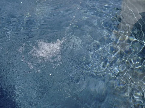 Water surface with stream of falling water. Decreasing water level. Stock Footage 75402530