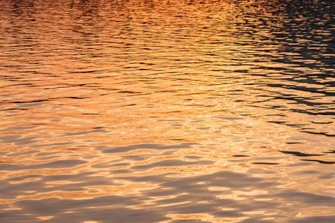Water surface at sunset Stock Photos
