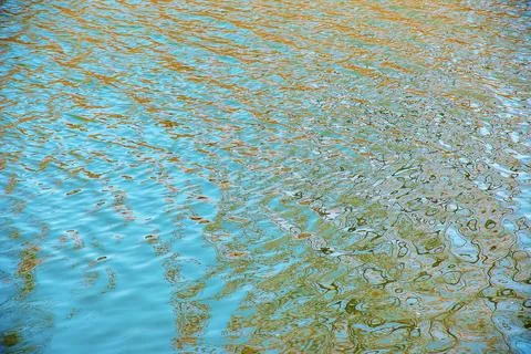 Water surface in sunset rays, river ripples or ocean with small waves, calm.. Stock Photos