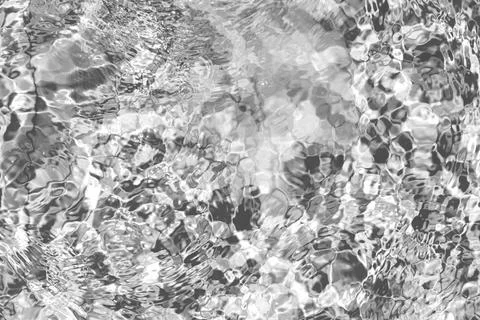 Water surface texture with drops. Caustics on the surface of the sea. Stock Photos