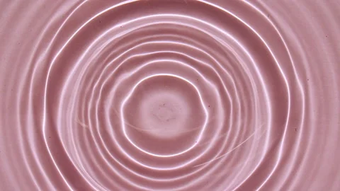 Water surface texture top view. Water splash pink colored. Pure blue water with Stock Footage 162812418