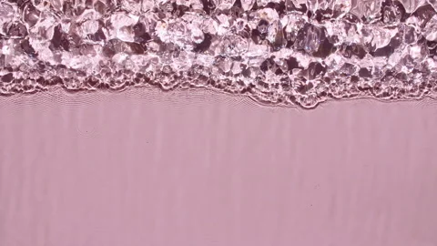 Water surface texture top view. Water splash pink colored. Pure blue water with Vídeo Stock 166789011