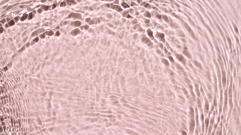 Water surface texture top view. Water waves pink colored. Sun and shadows. Pure 動画素材 255673354