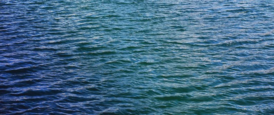 Water surface. The texture of the water. Waves on the lake in windy weather. Stock Photos