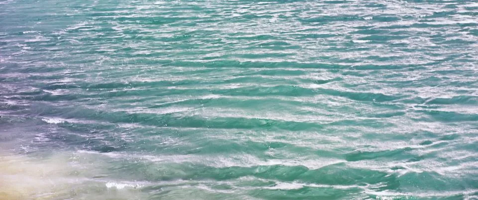 Water surface. The texture of the water. Waves on the lake in windy weather. Stock Photos