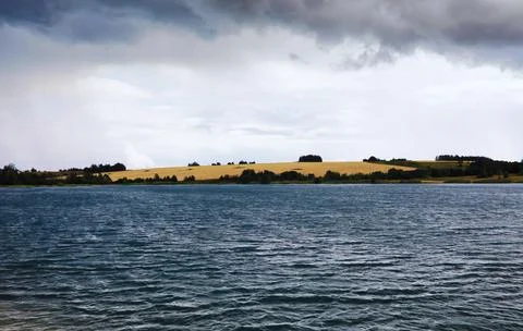 Water surface. The texture of the water. Waves on the lake in windy weather. Stock Photos