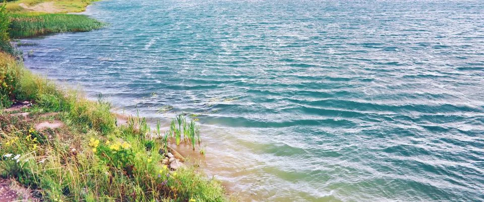 Water surface. The texture of the water. Waves on the lake in windy weather. Stock Photos