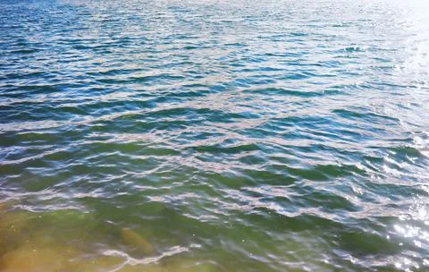 Water surface. The texture of the water. Waves on the lake in windy weather. Stock Photos