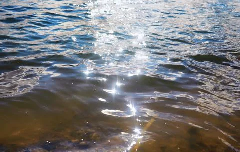 Water surface. The texture of the water. Waves on the lake in windy weather. Stock Photos