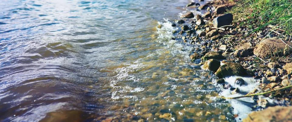 Water surface. The texture of the water. Waves on the lake in windy weather. Stock Photos