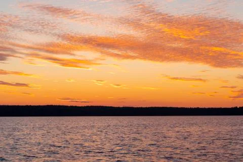 Water surface. View of a Sunset sky background. Dramatic gold sunset sky with Stock Photos