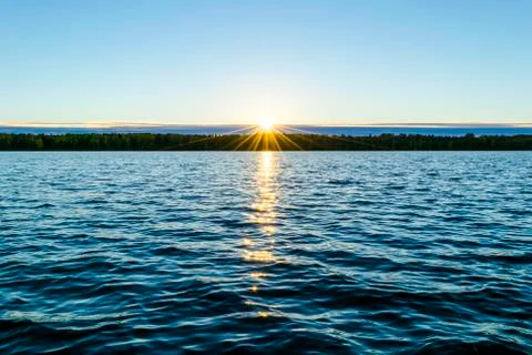 Water surface. View of a Sunset sky background. Dramatic gold sunset sky with Stock Photos