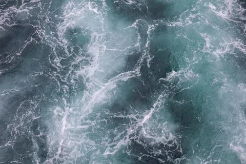 Water surface. Wake waves on the blue sea Stock Photos
