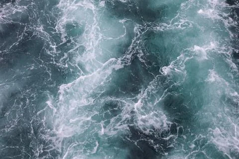 Water surface. Wake waves on the blue sea Stock Photos