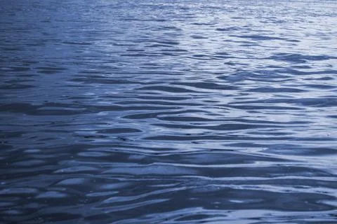 Water surface with waves, abstract, slightly defocused blue water background. Stock Photos