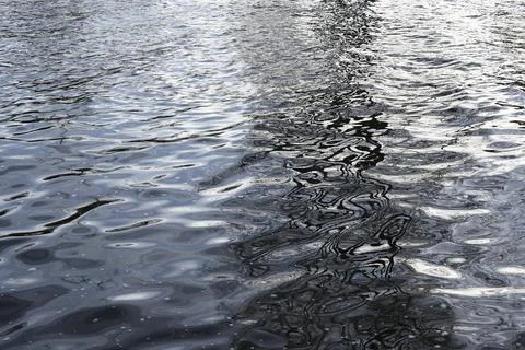 Water surface with waves and reflections Stock Photos