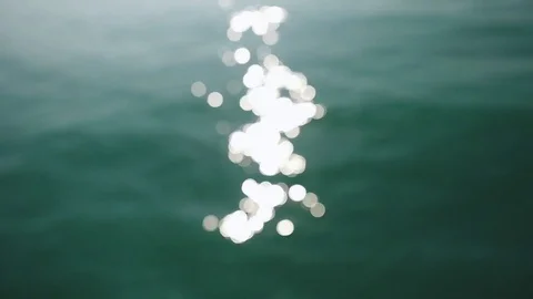 Water surface with waves glittering in the sun. Out of focus bokeh of sun glares Stock Footage 80126535