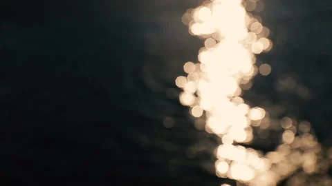 Water surface with waves glittering in the sun. Out of focus bokeh of sun glares Stock Footage 94635473