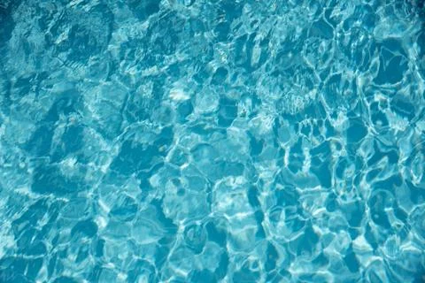 Water in swimming pool with sun reflection background Stock Photos
