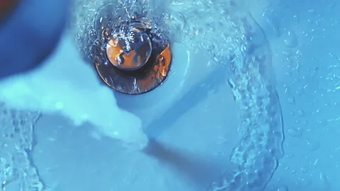 Water Swirling Down Sink Drain with Bubbles Macro Shot Video stock 344690566