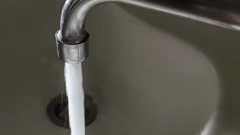Water from the tap flows into the sink. Concept of tariffs and prices per cubic Stock Footage 322092848