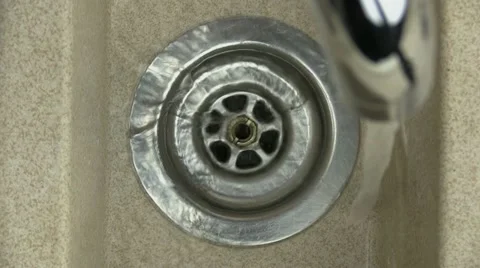 Water from a tap going down the kitchen sink Stock-Footage 21224652