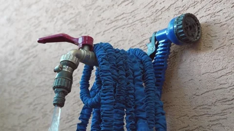 Water tap for watering garden plot. Man turns on valve and open water Vídeos de archivo 318035441