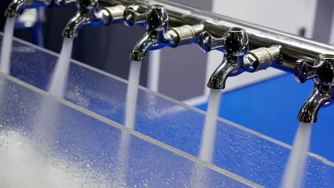 Water from the taps flows into a transparent container. Stock Footage 161242909