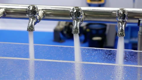 Water from the taps flows into a transparent container. Stock Footage 163052014