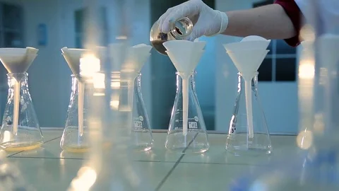 Water testing, laboratory chemist check clean water in flat bottom flask and Stock Footage