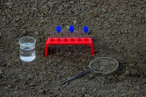 Water testing setup with test tube and ph meter on dark surface Stock Photos