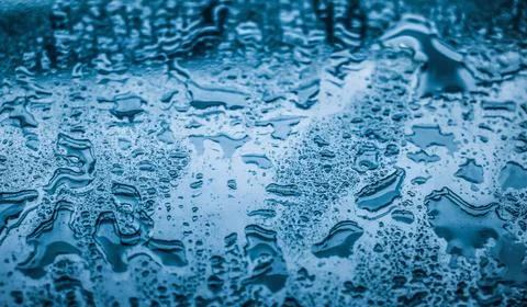 Water texture abstract background, aqua drops on blue glass as science mac... 写真素材