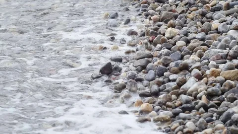 Water through pebbles on beach Stock Footage 74174749