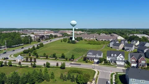 Water tower and surrounding suburb in Maple Lawn, Maryland drone forward flight Stock Footage 336698469