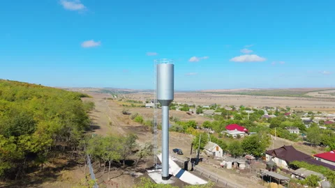 Water tower is highlighted in a rural setting, with a smooth zoom-in capturing Video stock 318716758