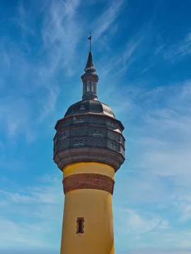 Water tower with an old construction, on a clear sky with a yellow column 写真素材