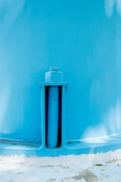 Water tower structure with blue paint shown in close up view during dayligh.. Stock Photos