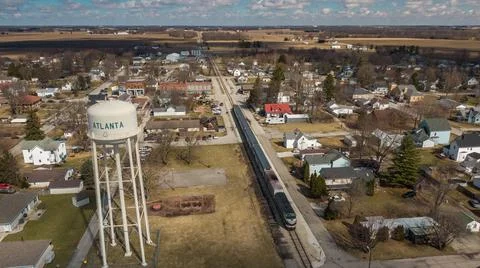 Water Tower with Train Drone in Small town USA, Atlanta, Indiana Stock Photos