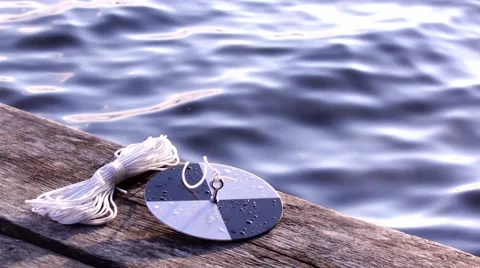Water transparency measuring Secchi disc on a wooden dock Stock Footage 68405638