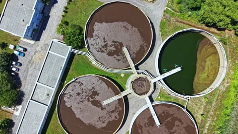 Water treatment facilities process wastewater in large round tanks in a rural Video stock 337879915
