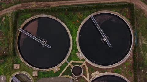 Water treatment facility with large circular tanks and processes Stock Footage 321494052