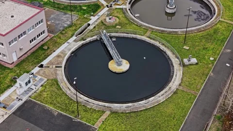 Water treatment facility with large circular tanks in view Stock Footage 332209932