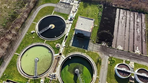 Water treatment facility operates with multiple tanks and processing units in an Stock Footage 335403687